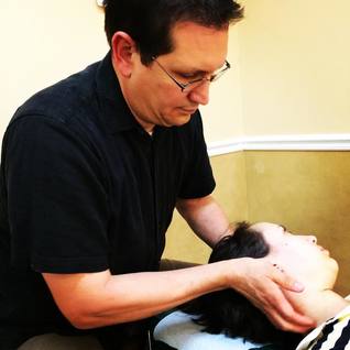 Dr. Donn Blencowe gives a patient a cervical chiropractic adjustment